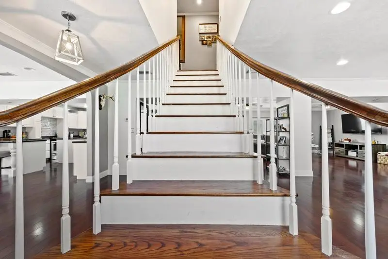 Beautiful stairway in two-story home in Lake City, Florida listed by Chelsea Morgan